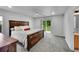 The main bedroom boasts a sliding glass door to the backyard and plush carpet at 5577 Jasper St, Denver, CO 80239