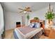 This carpeted bedroom features a ceiling fan, hanging plant, and ample natural light at 3355 S Flower St # 107, Lakewood, CO 80227