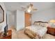 Comfortable bedroom featuring ceiling fan, closet, and view of stairs leading upstairs at 3355 S Flower St # 107, Lakewood, CO 80227