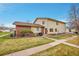 Charming home featuring well-maintained landscaping and a combination of brick and vinyl siding at 3355 S Flower St # 107, Lakewood, CO 80227