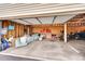 Spacious garage with concrete floor, storage on the back wall, and room for vehicles at 3355 S Flower St # 107, Lakewood, CO 80227