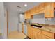 Functional kitchen area featuring a stainless steel microwave, black sink, and white appliances at 3355 S Flower St # 107, Lakewood, CO 80227