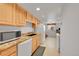 Spacious kitchen featuring granite countertops, wood cabinets, and stainless steel microwave at 3355 S Flower St # 107, Lakewood, CO 80227