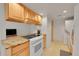 Charming kitchen featuring granite countertops, wood cabinets, and modern white appliances at 3355 S Flower St # 107, Lakewood, CO 80227