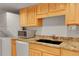 Efficient kitchen layout with stainless steel microwave, white appliances, and black sink at 3355 S Flower St # 107, Lakewood, CO 80227