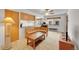 Open-concept living area with built-in seating, adjacent kitchen space, and television at 3355 S Flower St # 107, Lakewood, CO 80227