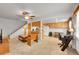 Inviting living area with a ceiling fan, adjacent kitchen, and staircase at 3355 S Flower St # 107, Lakewood, CO 80227
