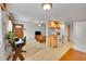 Open-concept living space with neutral flooring, updated appliances, and exterior access at 3355 S Flower St # 107, Lakewood, CO 80227