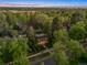 Stunning aerial view of a classic brick home nestled among mature trees in a lush, green neighborhood at 6300 E 17Th Avenue Pkwy, Denver, CO 80220