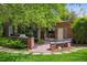 Beautiful backyard features a brick patio with a grill, bench seating, and lush greenery at 6300 E 17Th Avenue Pkwy, Denver, CO 80220