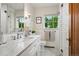 Charming bathroom with a marble countertop vanity, subway tile shower, and classic fixtures at 6300 E 17Th Avenue Pkwy, Denver, CO 80220