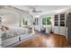 Bright bedroom with a canopy bed, hardwood floors, and large windows offering natural light at 6300 E 17Th Avenue Pkwy, Denver, CO 80220