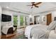 Bedroom with a large bed, french doors to the outside and an upholstered chair at 6300 E 17Th Avenue Pkwy, Denver, CO 80220