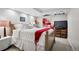 Cozy bedroom with carpet, bright lighting, and a bed with white bedding and a red throw blanket at 6300 E 17Th Avenue Pkwy, Denver, CO 80220