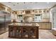Spacious kitchen with custom cabinets, a large island, and stainless steel refrigerator at 6300 E 17Th Avenue Pkwy, Denver, CO 80220