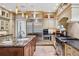 Bright kitchen with a stainless steel refrigerator, large island, and gourmet stove at 6300 E 17Th Avenue Pkwy, Denver, CO 80220