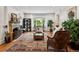 Spacious living room featuring a fireplace, large rug and view to the outside at 6300 E 17Th Avenue Pkwy, Denver, CO 80220