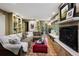 Comfortable living room with built-in shelves, fireplace and glass paneled french doors at 6300 E 17Th Avenue Pkwy, Denver, CO 80220