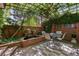 Charming patio features lush greenery, stone fountain, string lights, and comfortable seating at 6300 E 17Th Avenue Pkwy, Denver, CO 80220