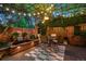 Inviting brick patio with lush greenery, overhead string lights, a brick fountain, and a stylish dining area at 6300 E 17Th Avenue Pkwy, Denver, CO 80220