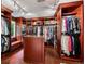 Spacious walk-in closet featuring custom wood shelving, ample storage, and a central island at 6300 E 17Th Avenue Pkwy, Denver, CO 80220