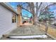 Back deck featuring chairs, table, grill, and partial winter snow at 3863 S Bahama St, Aurora, CO 80013