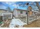 Backyard featuring a wooden deck, a large tree and partial winter snow at 3863 S Bahama St, Aurora, CO 80013