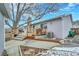 Backyard featuring a wooden deck, patio, lush tree and partial winter snow at 3863 S Bahama St, Aurora, CO 80013
