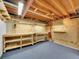 Unfinished basement featuring work benches, wood shelving and a carpeted floor at 3863 S Bahama St, Aurora, CO 80013