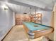 Unfinished basement featuring a pool table, light fixture, and mural at 3863 S Bahama St, Aurora, CO 80013