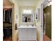 Well-lit bathroom with a bright vanity, decorative mirror, and a separate closet for storage at 3863 S Bahama St, Aurora, CO 80013