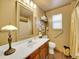 Traditional bathroom with wood vanity, a large decorative mirror, and an enclosed shower-bath tub at 3863 S Bahama St, Aurora, CO 80013