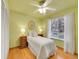 Bright bedroom showcasing a single bed, wooden floor, and natural light from the window at 3863 S Bahama St, Aurora, CO 80013
