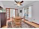 Cozy dining area featuring a wooden table, decorative rug, and natural light from the adjacent window at 3863 S Bahama St, Aurora, CO 80013