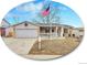 Charming single-Gathering home with a well-manicured lawn, complemented by an American flag at 3863 S Bahama St, Aurora, CO 80013