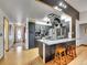 Modern kitchen design featuring black cabinets, a stainless steel refrigerator, and wooden breakfast bar stools at 3863 S Bahama St, Aurora, CO 80013