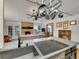 Open kitchen showcasing sink and cooktop with view of a brick fireplace and cozy living area at 3863 S Bahama St, Aurora, CO 80013