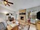 Comfortable living room featuring a brick fireplace, cozy seating, and natural light at 3863 S Bahama St, Aurora, CO 80013