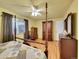 Bright primary bedroom with a four-poster bed, dark wood furniture, and a ceiling fan at 3863 S Bahama St, Aurora, CO 80013