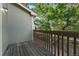 Wood balcony featuring brown railing and siding along with a view of surrounding trees at 1885 S Quebec Way # A28, Denver, CO 80231