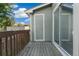 View of wooden balcony with gray siding and a sliding glass door at 1885 S Quebec Way # A28, Denver, CO 80231
