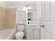 Bright bathroom featuring a tub with tile surround, toilet, vanity and a mirror at 1885 S Quebec Way # A28, Denver, CO 80231