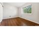 Bedroom featuring hard wood floors, baseboard trim and one window at 1885 S Quebec Way # A28, Denver, CO 80231