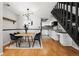 Contemporary dining room with modern light fixture and open access to the updated kitchen at 1885 S Quebec Way # A28, Denver, CO 80231