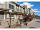 Townhome exterior featuring a landscaped walkway leading to the front door at 1885 S Quebec Way # A28, Denver, CO 80231