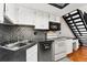 Modern kitchen with stainless steel appliances, stylish backsplash, and white cabinets at 1885 S Quebec Way # A28, Denver, CO 80231