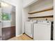 Laundry room featuring a washing machine and dryer along with shelves at 1885 S Quebec Way # A28, Denver, CO 80231