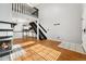 Open-concept living area with fireplace, modern staircase, and view of the updated kitchen at 1885 S Quebec Way # A28, Denver, CO 80231