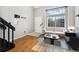 Cozy living room with hardwood floors, neutral paint, and bright, large windows at 1885 S Quebec Way # A28, Denver, CO 80231