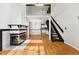 Spacious living room with a fireplace, modern black staircase, and open layout to the kitchen at 1885 S Quebec Way # A28, Denver, CO 80231
